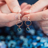 Image shows model holding Rose Gold Circle Birthstone Earrings