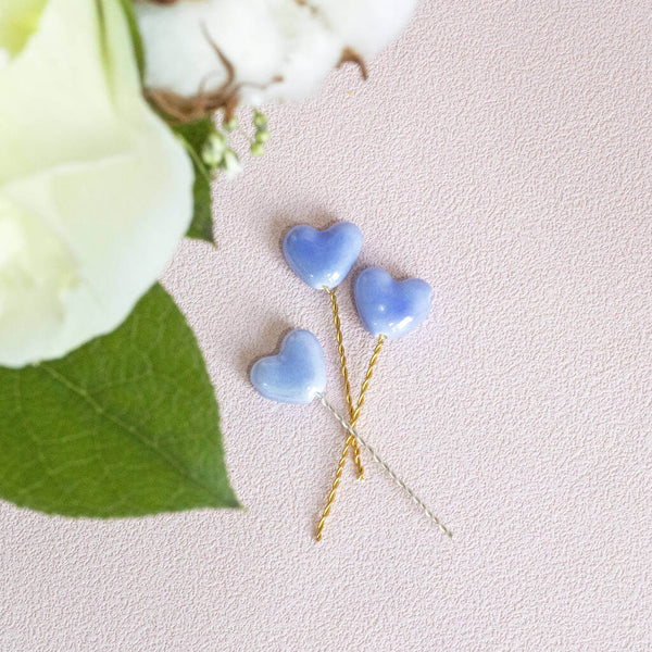 Image shows blue heart pins for wedding flowers