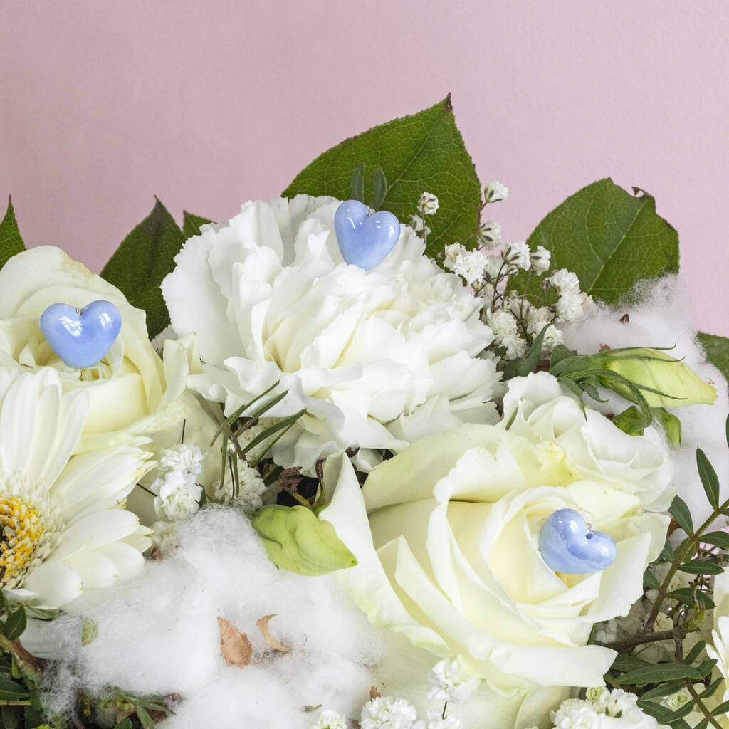 Image shows something blue heart pins in a bridal bouquet