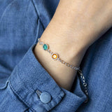Image shows model wearing silver double birthstone bracelet with December and November birthstones