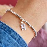 Image shows model wearing Silver Plated Beaded Bracelet With Birthstone Initial