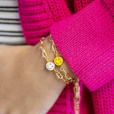 Image shows model wearing white and yellow Smiley Face Bracelets
