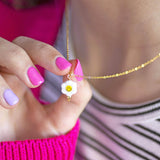 Images shows model holding Smiley Face Flower Necklace
