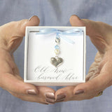 Model hold a gift box with something blue brides heart charm on old new borrowed blue sentiment card