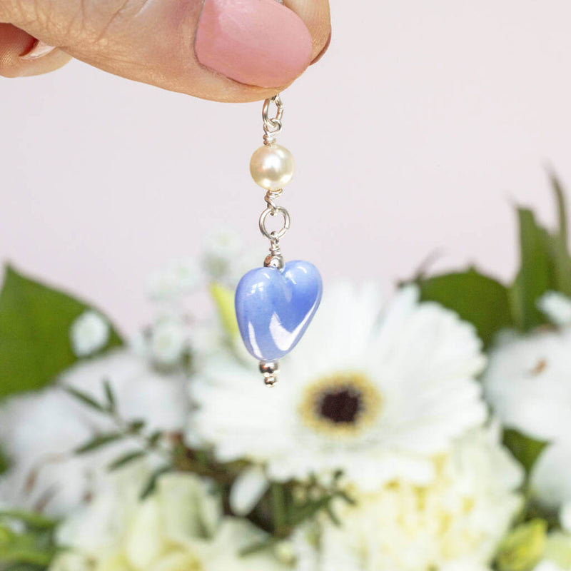 Image shows model holding Something Blue Ceramic Heart Keepsake Charm 