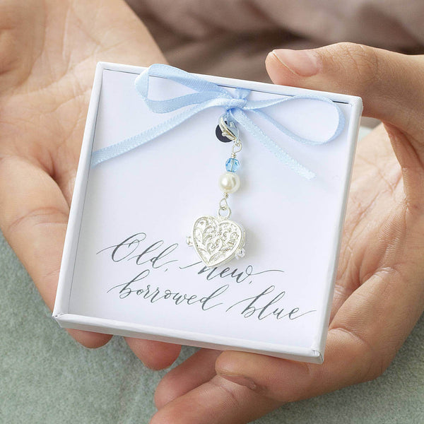 Something blue locket charm in a gift box on and old new borrowed blue sentiment card attached  ti baby blue ribbon