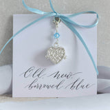 Something blue locket charm  on an old new borrowed blue sentiment card attached to baby blue ribbon