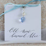 Image shows something blue Swarovski crystal bridal charm on an 'old, new' borrowed, blue' sentiment card attached with a blue ribbon.