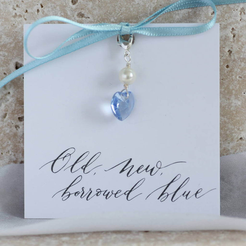 Image shows something blue Swarovski crystal bridal charm on an 'old, new' borrowed, blue' sentiment card attached with a blue ribbon.