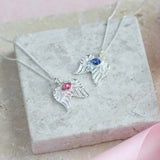 Image shows two sterling silver angel wings birthstone necklace one with October birthstone and the other with September