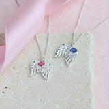 Image shows two sterling silver angel wings birthstone necklace one with October birthstone and the other with Septembe