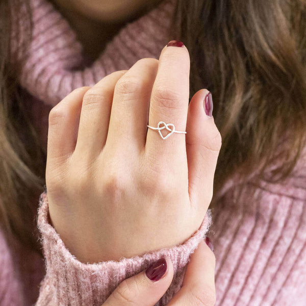 Image shows model wearing sterling silver friendship knot heart ring