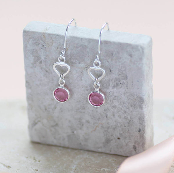 Image shows sterling silver heart birthstone earrings with October birthstone