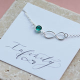 Image shows Sterling Silver Infinity Birthstone Bracelet with December on an Infinity sentiment card