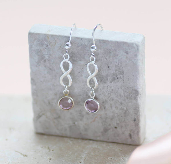 Image shows sterling silver infinity birthstone earrings with October birthstone