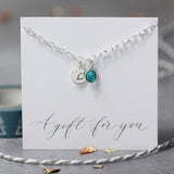 Image shows sterling silver personalised birthstone bracelet with initial L on disc and December birthstone, on A gift for you sentiment card