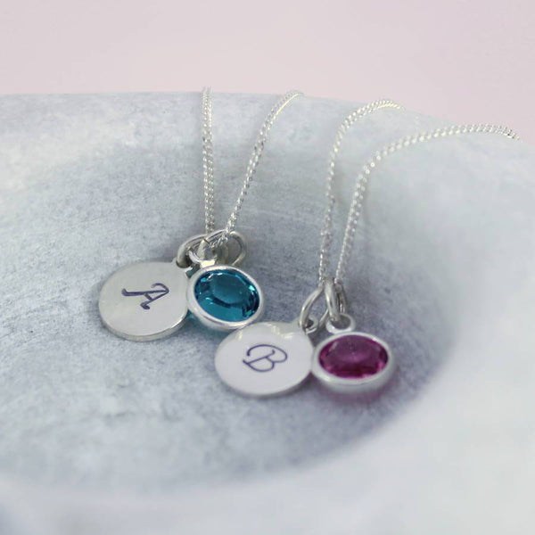 Image shows two  sterling silver personalised birthstone necklaces