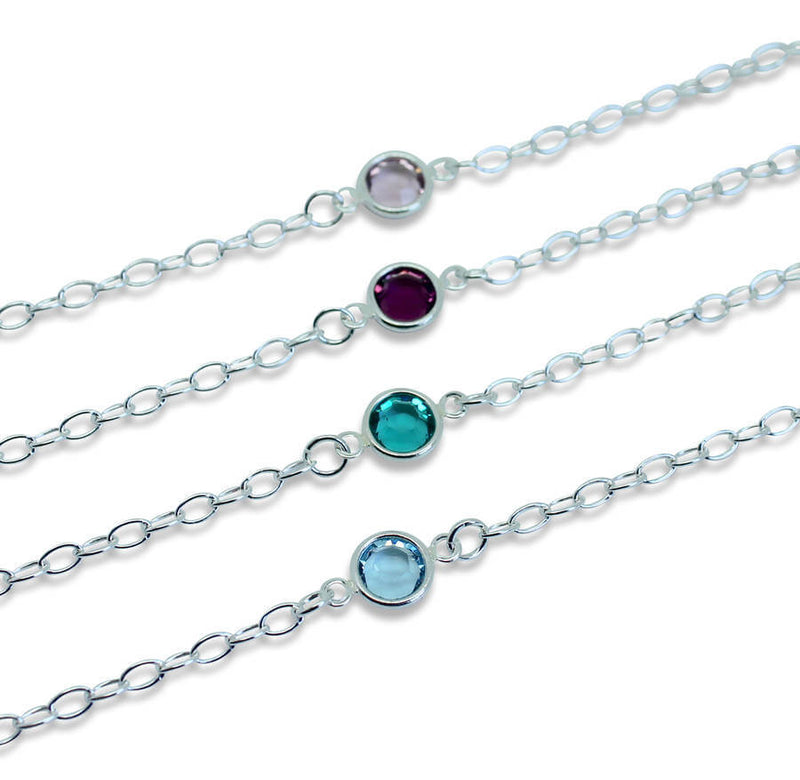 Image shows a selection of Sterling Silver Swarovski Crystal Birthstone Bracelets