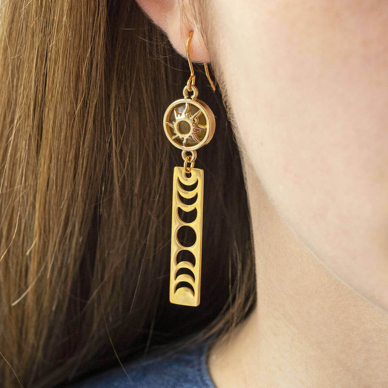 Image shows model wearing  green Sun and Moon Phases Long Drop Earrings