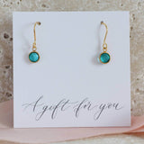 Image shows gold Swarovski crystal birthstone earrings with December birthstone on a gift for you sentiment card