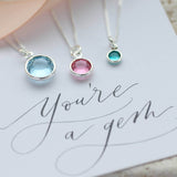 Image shows all 3 sizes of the Swarovski crystal birthstone pendant necklaces
