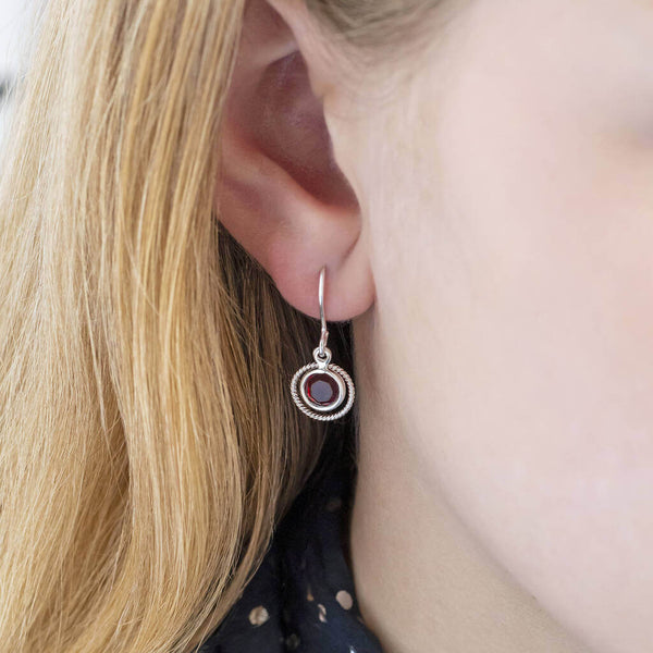 Image shows model wearing Swarovski eternity birthstone earrings with July birthstone