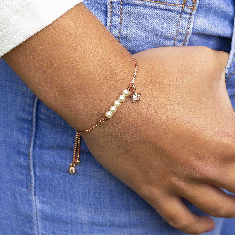 Image shows model wearing rose gold Swarovski Pearl Slider Charm Bracelet