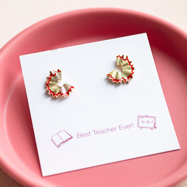 Image shows a pair of Teacher Gift Pencil Shaving Earrings on a 'best teacher ever' sentiment card on a pink backdrop.