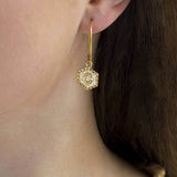 Image shows model wearing gold Textured Hexagon Initial Hoop Earrings
