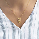 Image shows model wearing Triple Pearl Drop Circle Charm Necklace