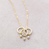 Image shows Triple Pearl Drop Circle Charm Necklace