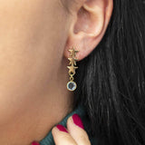 Image shows model wearing triple star birthstone earrings 