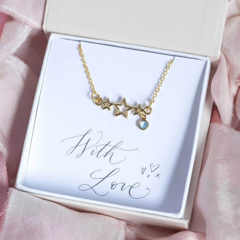 Image shows Triple Star Necklace With Mini Birthstone with March birthstone in a gift box on a with love  sentiment card
