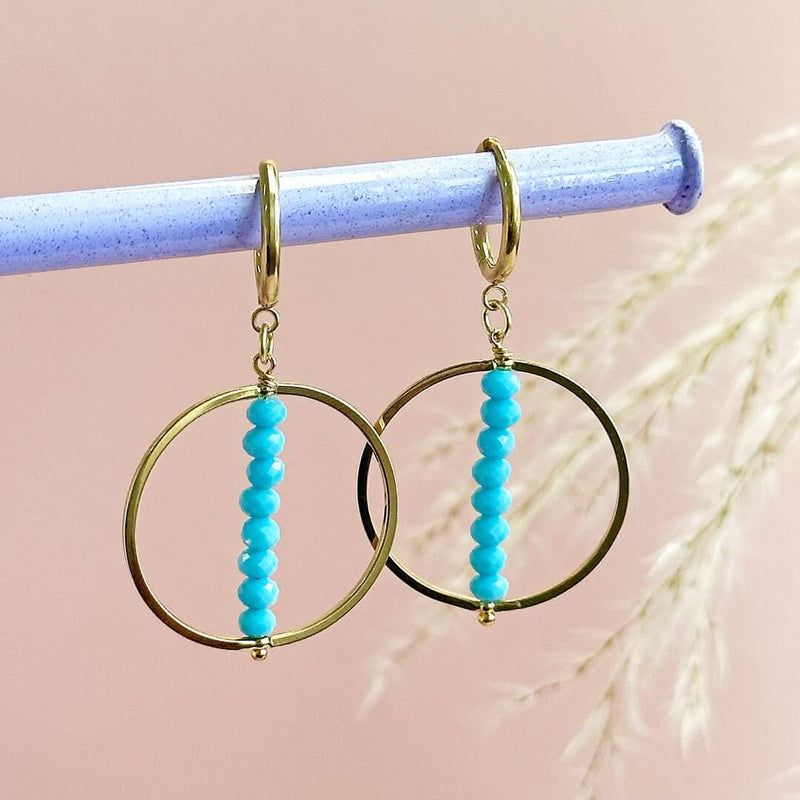 Image shows Turquoise Beaded Stack Crystal Earrings hand from a grey pole