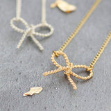Image shows silver and gold Twisted Bow Knot Necklaces