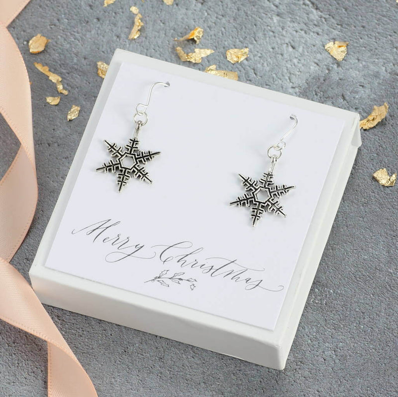 Image show vintage style snowflake earrings in a gift box on a Merry Christmas sentiment card