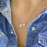 Image shows model wearing silver Wear It With JOY Necklace