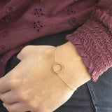 Image shows model wearing What Goes Around Comes Around Good Karma Bracelet