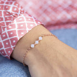 Image shows model wearing rose gold White Opal Swarovski Crystal Bar Bracelet