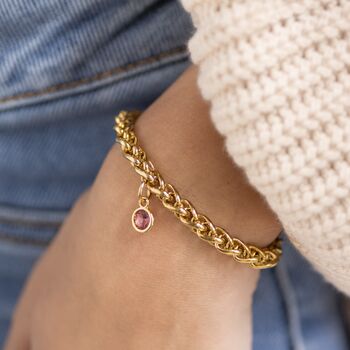 Gold plated chunky rope chain bracelet with a pink birthstone charm, bold layering jewellery for everyday style.