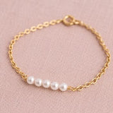 Gold plated Swarovski pearl bracelet with four luminous pearls, minimalist jewellery for stacking with favourites.