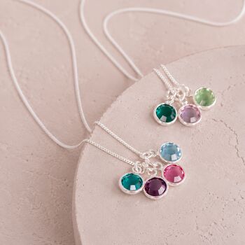 Silver birthstone charm pendants with colourful crystal details, timeless personalised jewellery for layering.