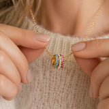 Gold family birthstone rings necklace with stacked colourful crystal rings, a vibrant layering piece