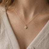 Delicate gold plated four leaf clover necklace, minimalist layering jewellery with a polished lucky charm.