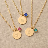 Gold plated initial disc necklace with pink birthstone crystal charm, perfect for layering with colourful personalised jewellery.