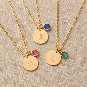 Gold plated initial disc necklace with pink birthstone crystal charm, perfect for layering with colourful personalised jewellery.