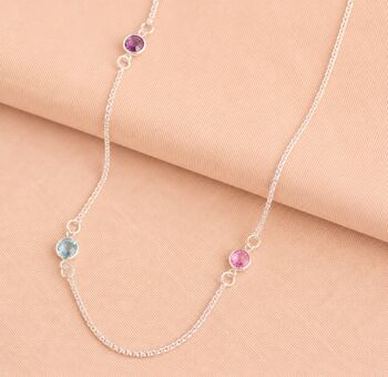 Silver long birthstone necklace with pink, purple and blue crystal accents, colourful layered jewellery with a modern finish.