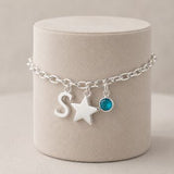 Silver charm bracelet with letter S, star pendant and aqua birthstone crystal for everyday wear
