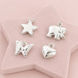 Silver charm collection featuring heart, butterfly, elephant and star charms for custom bracelets