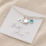 Silver children's charm bracelet with letter A, star pendant and blue birthstone presentation card